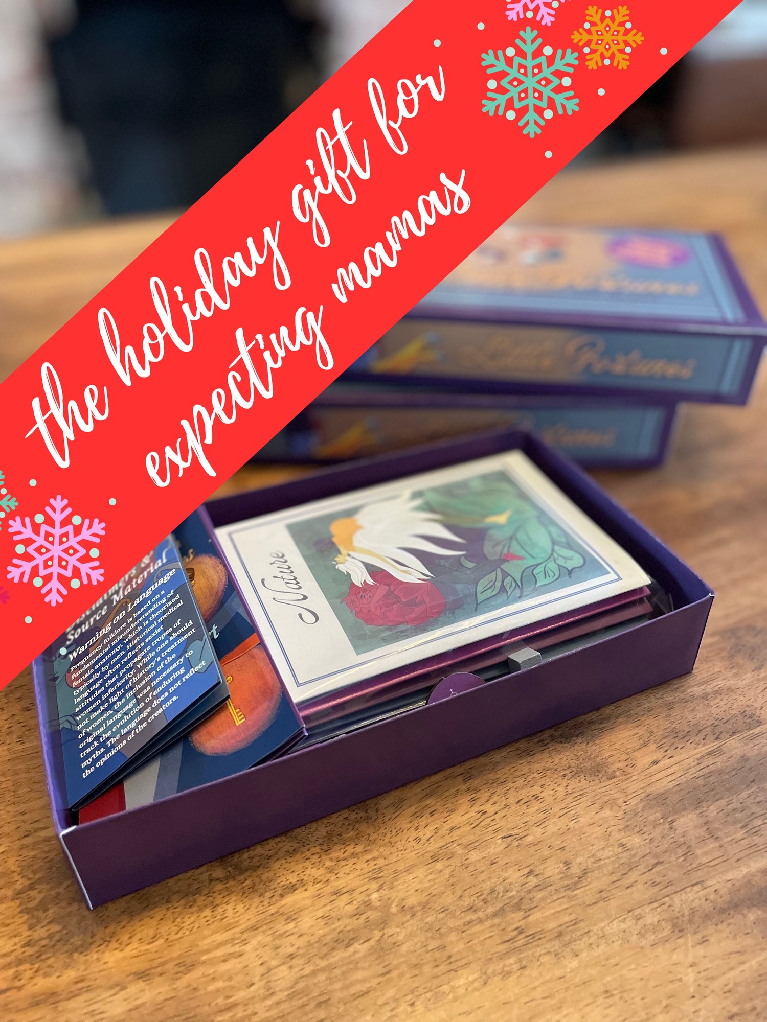 A purple game box with cards and booklets displaying unique and modern illustrations of old wives tales and folklore with Victorian and Art Deco elements. Perfect holiday gift for Christmas for pregnant women and expecting couples.